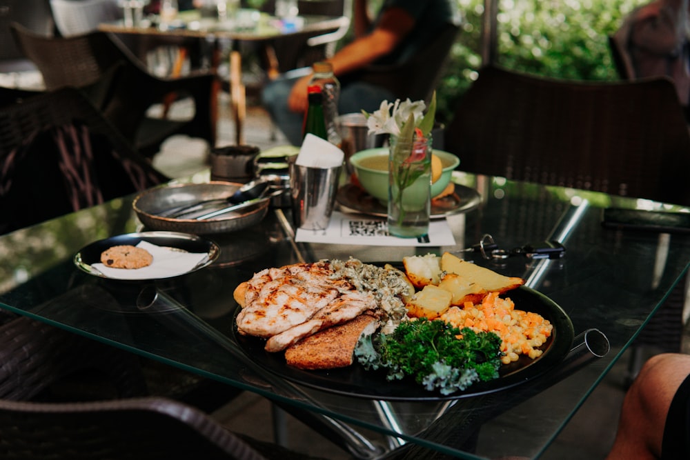 a glass table topped with a plate of food