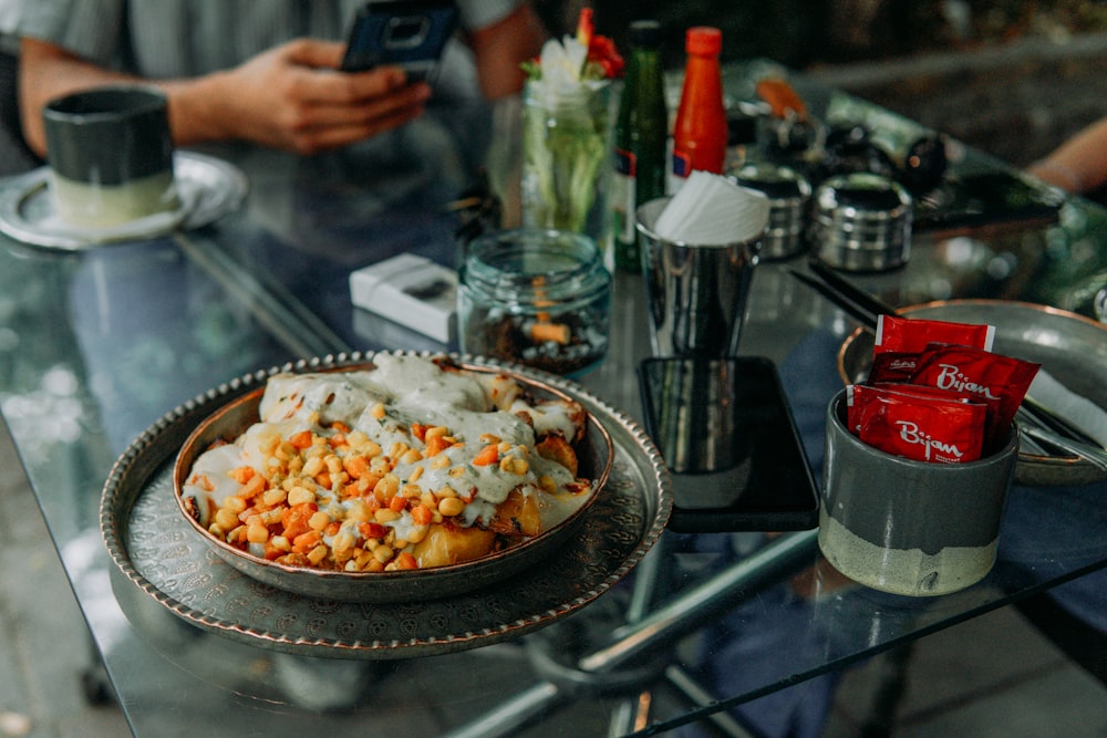 a plate of food sitting on a glass table