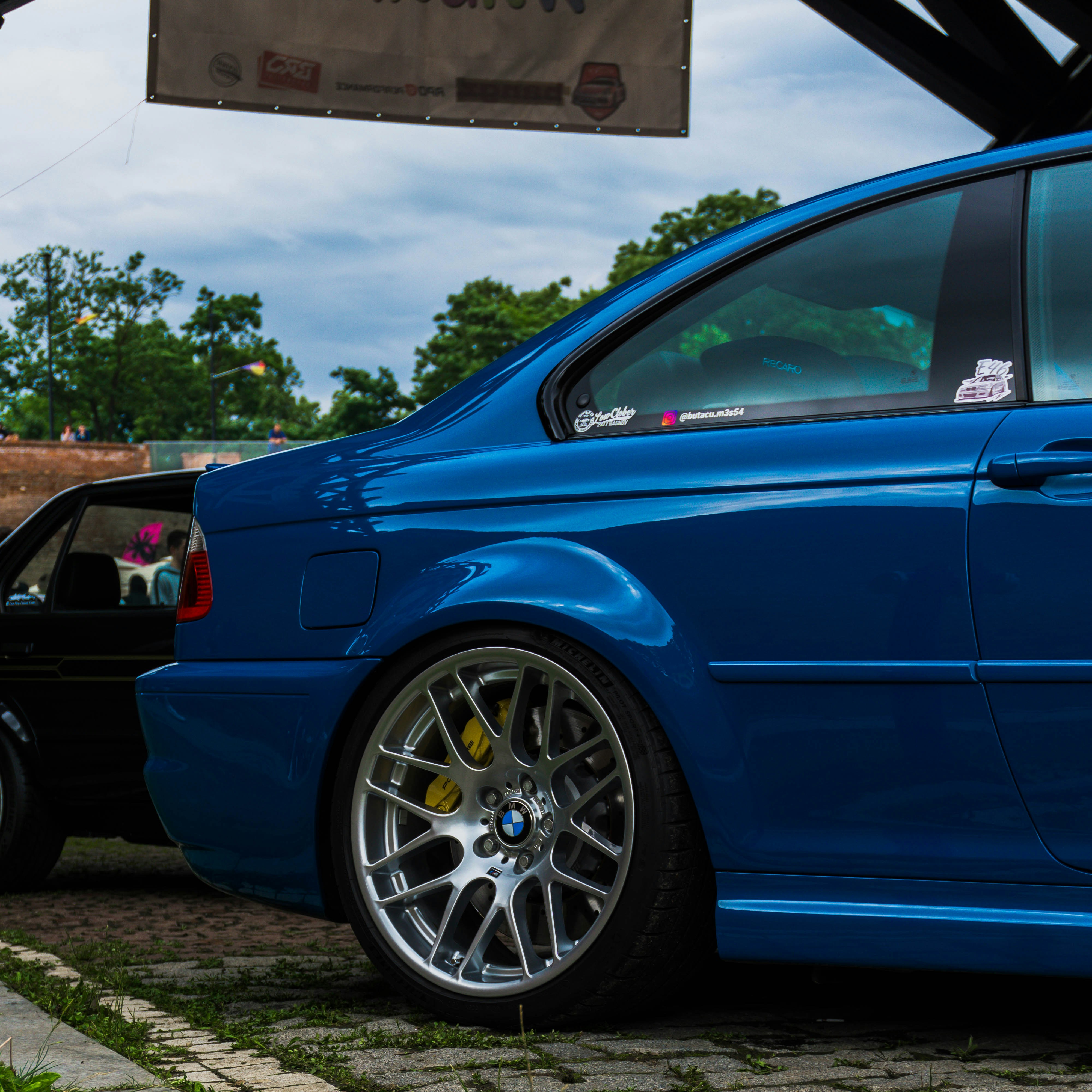 a blue car parked in front of a building