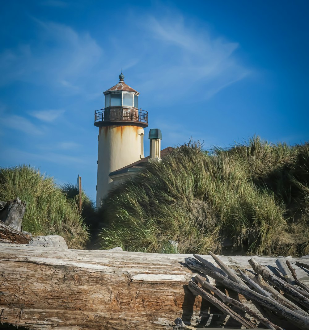 a light house sitting on top of a sandy beach