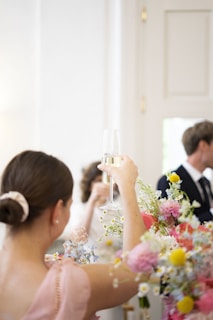 A group of authors sharing a toast at a classy evening gathering, dressed in elegant black and gold attire.