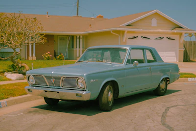 Claws Pest Control van parked outside a suburban house under ultramarine blue sky.