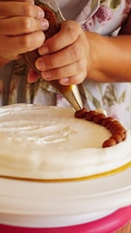 a person cutting a cake with a knife