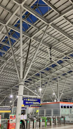 Interior view of a bustling transit hub showcasing modern electrical infrastructure and fire safety installations.