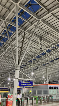 Interior view of a bustling transit hub showcasing modern electrical infrastructure and fire safety installations.