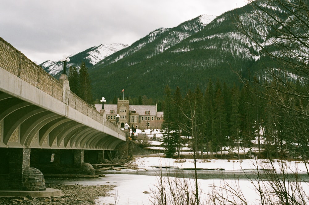 a bridge over a river with a mountain in the background