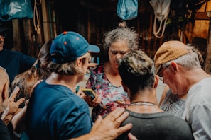 A small group gathered in heartfelt prayer inside a cozy church room.