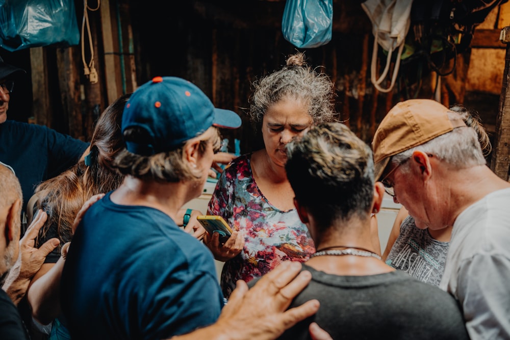 a group of people standing around each other