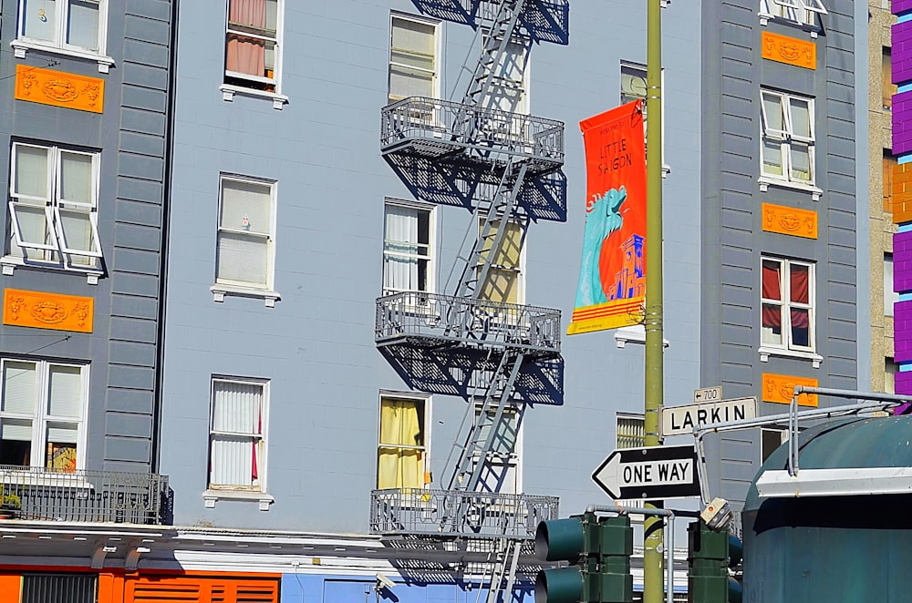 a tall building with a fire escape next to a traffic light