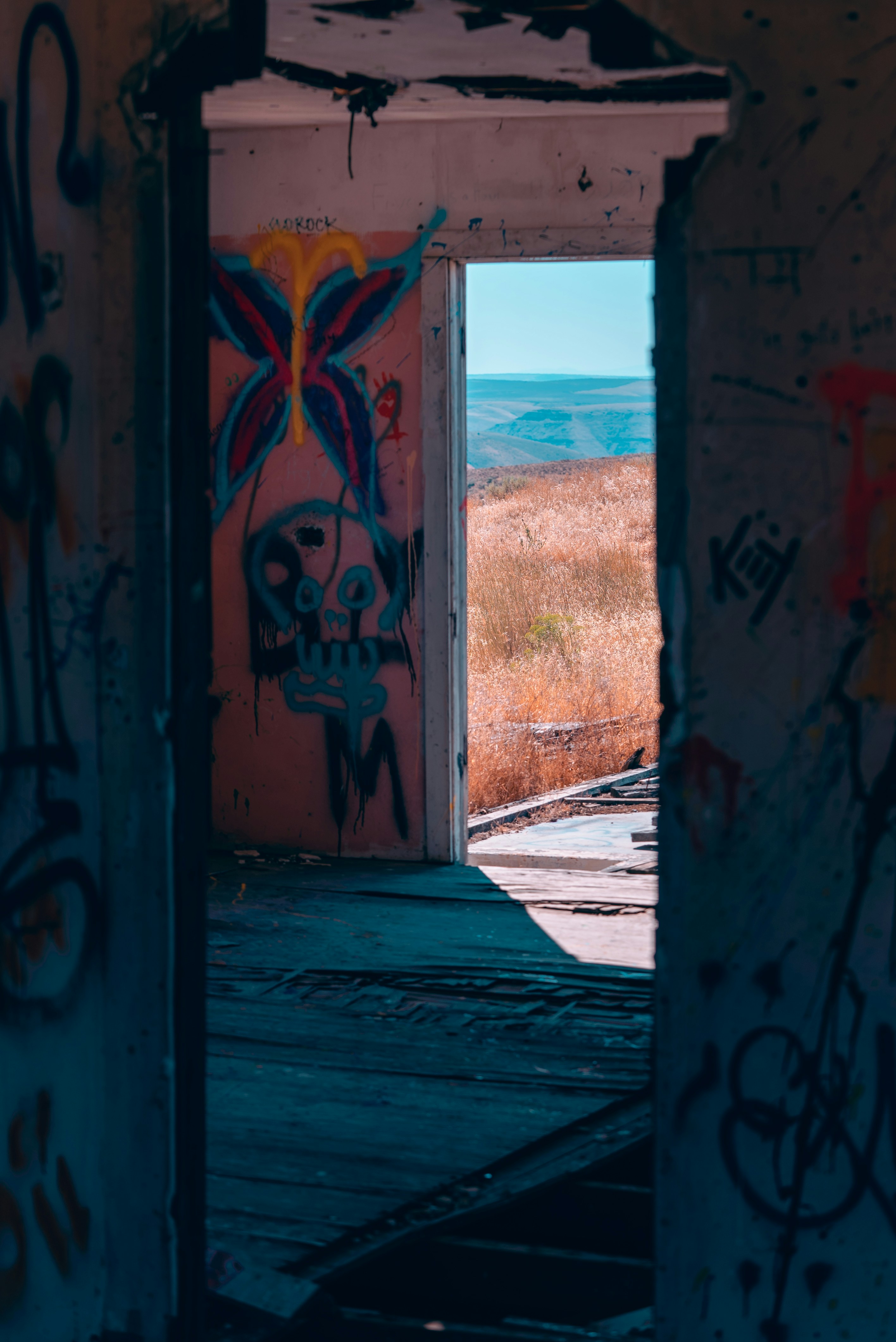 an open doorway with graffiti on the walls