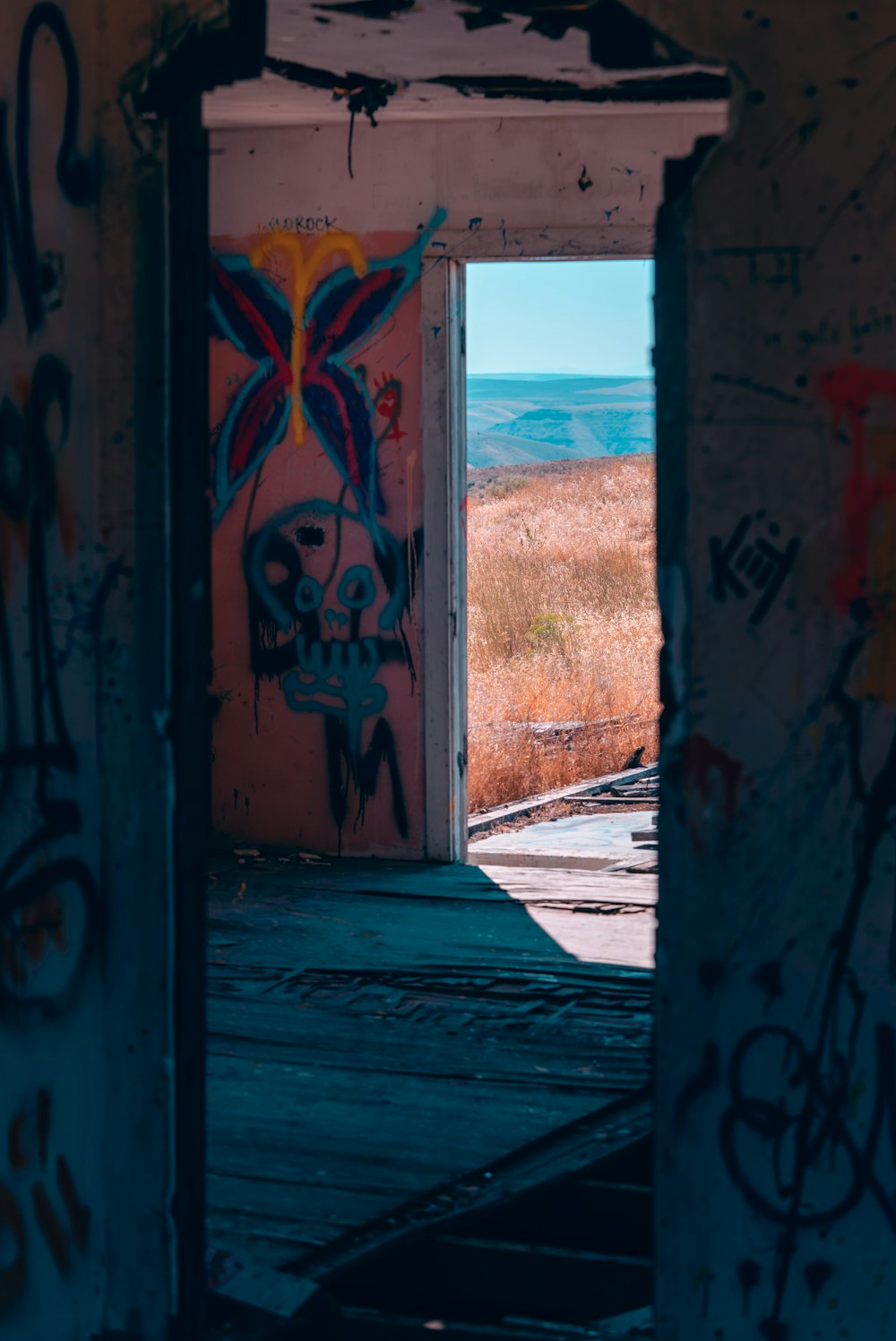 an open doorway with graffiti on the walls