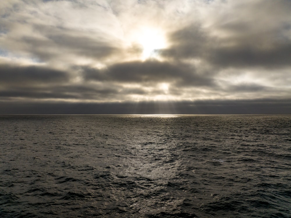 a large body of water under a cloudy sky