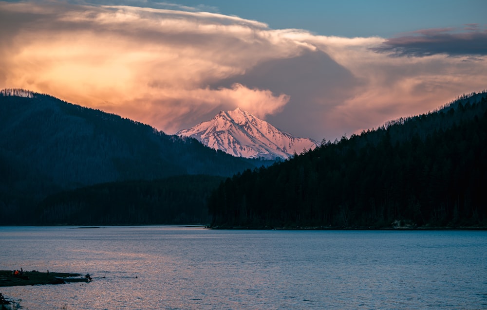 a mountain range with a lake in the foreground