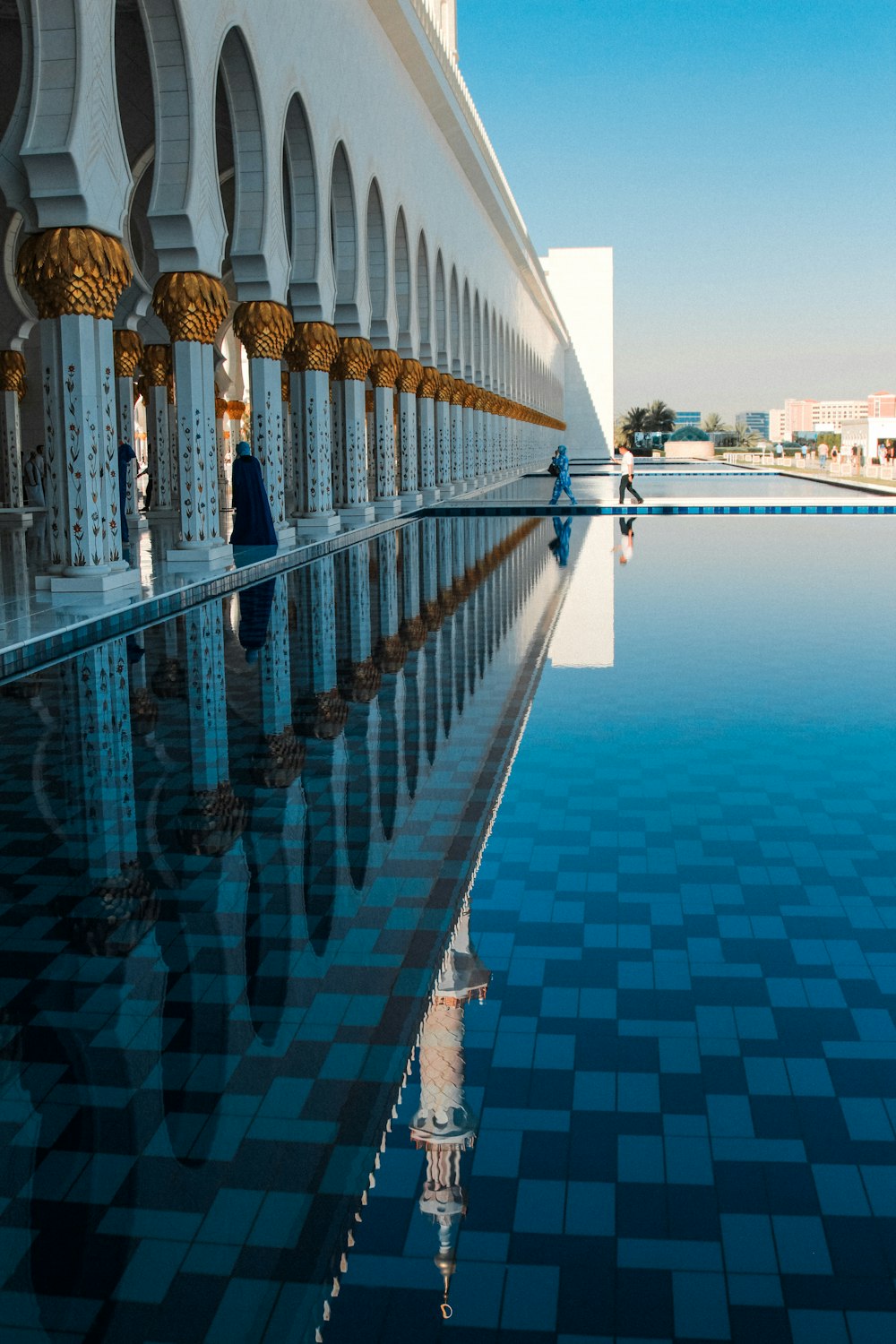a pool with a reflection of a building in it