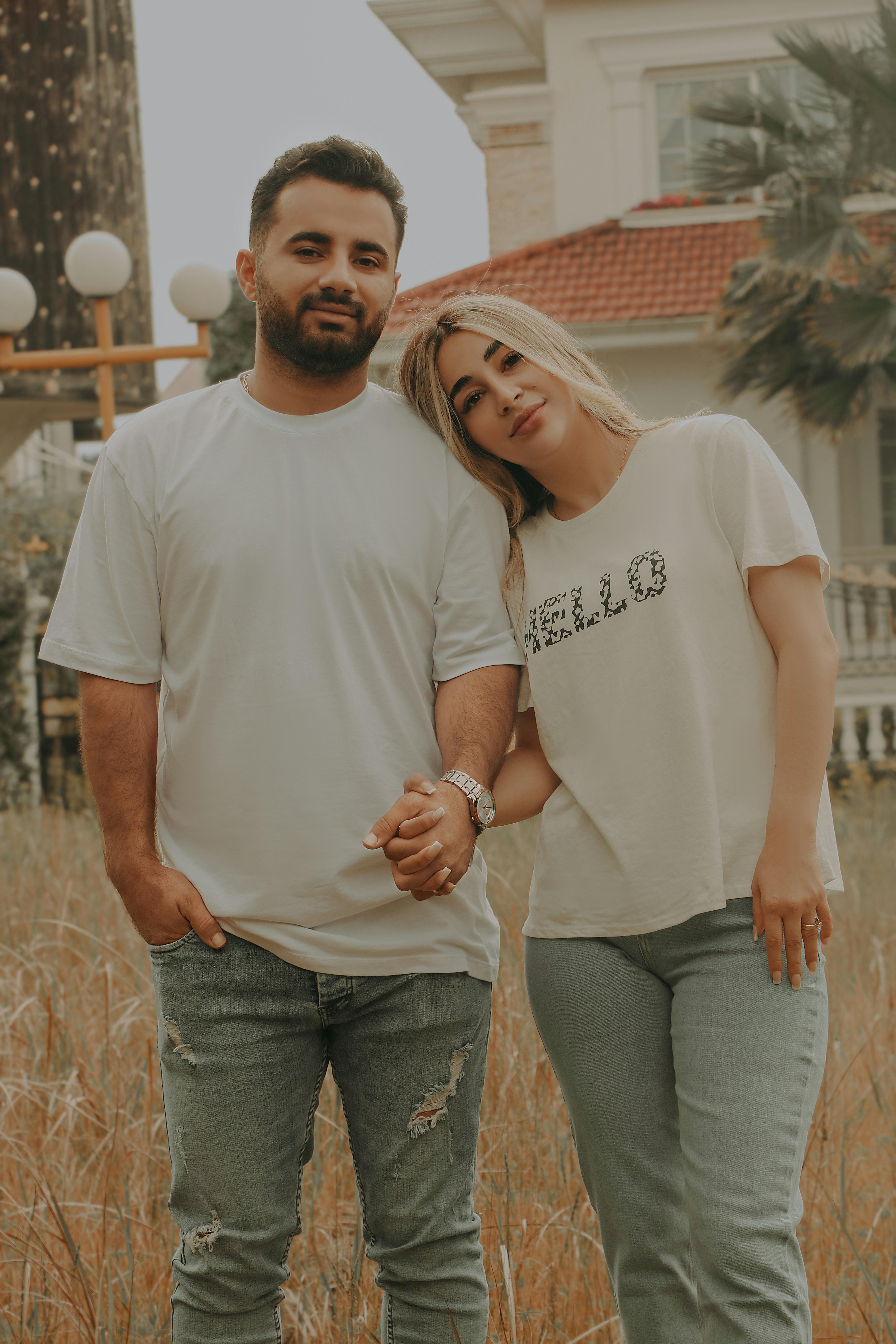 a man and a woman standing in a field
