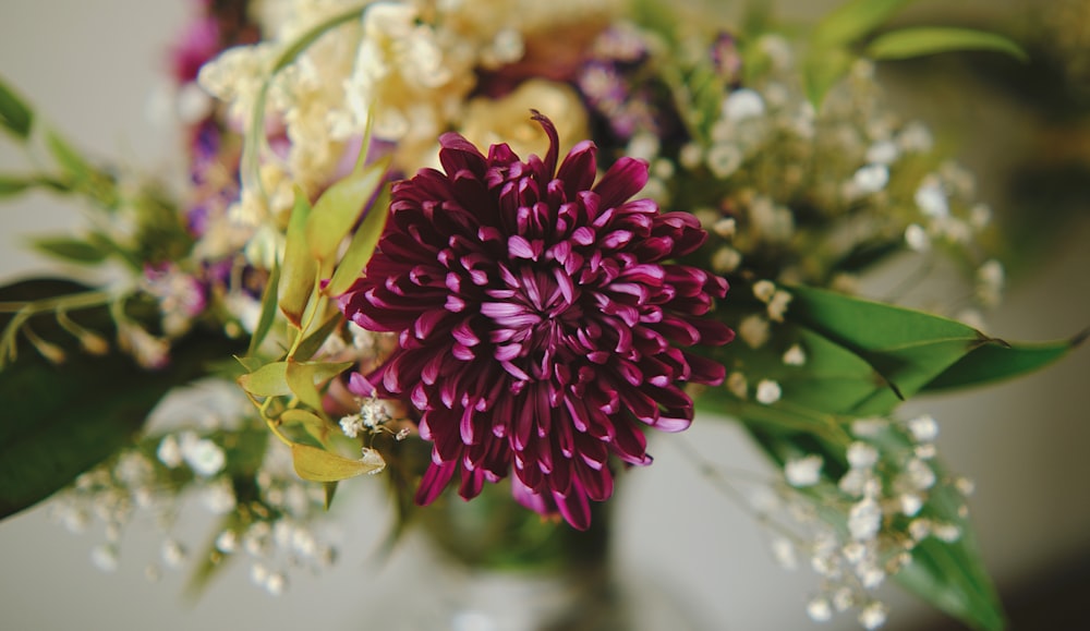 a bouquet of flowers in a vase on a table