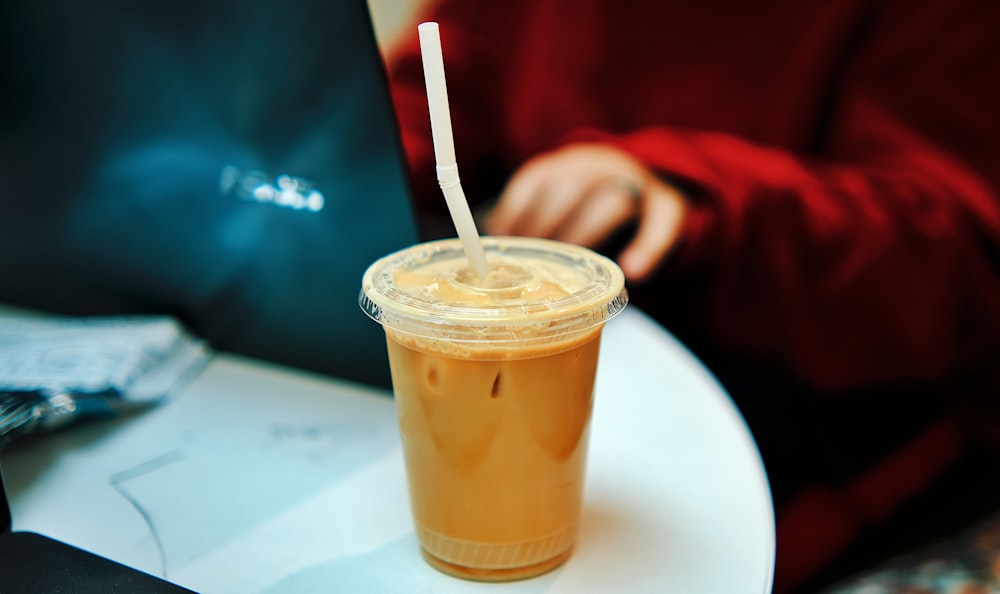 a cup of iced coffee sitting on a table