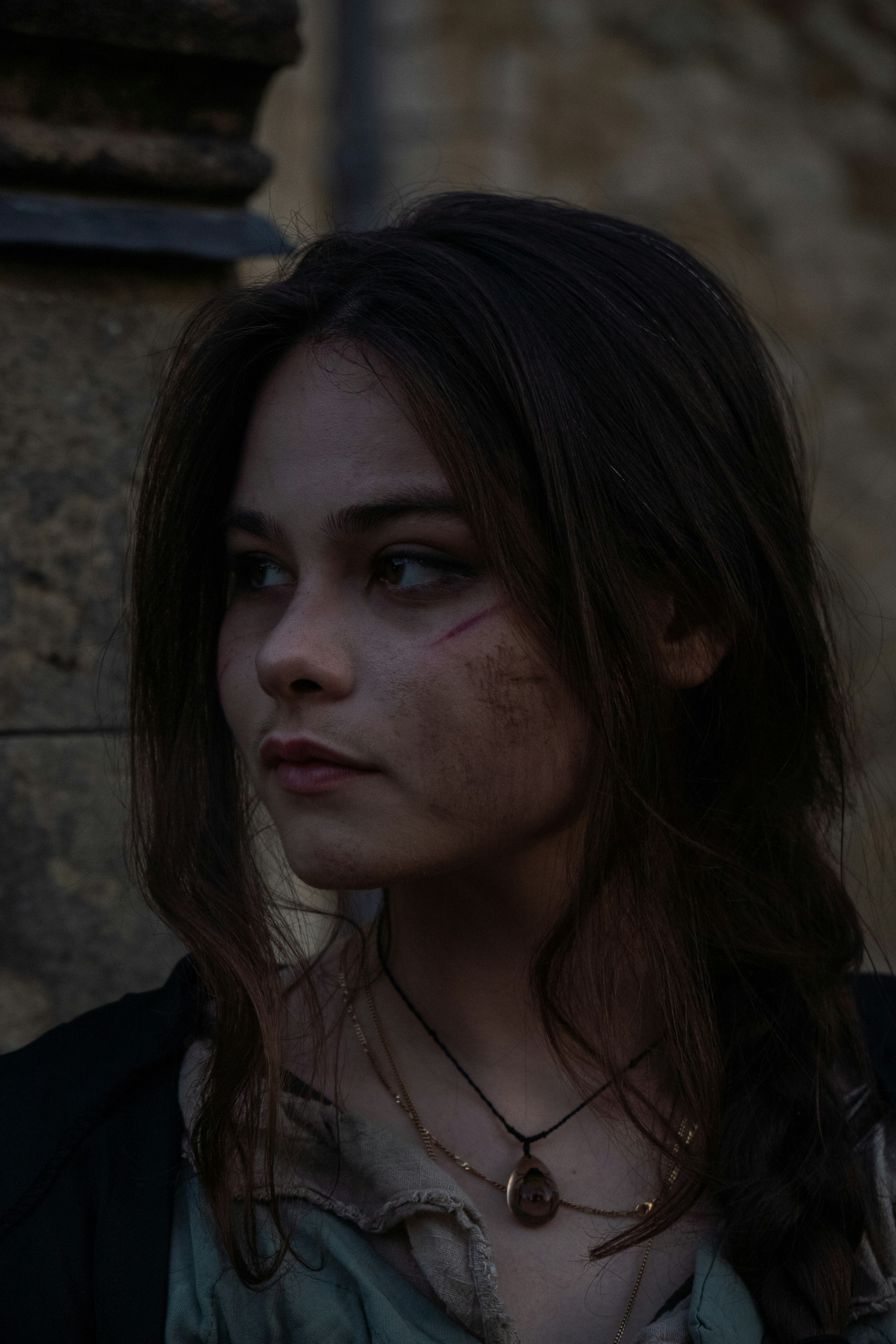 a woman with makeup on her face standing in front of a building