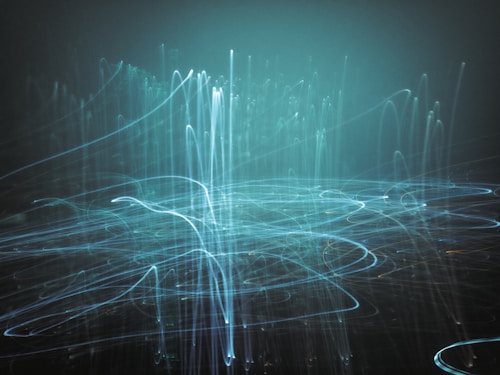 An abstract image featuring multiple curved and straight streaks of light in various directions against a dark background. The lights appear in shades of blue and create a sense of movement and fluidity.