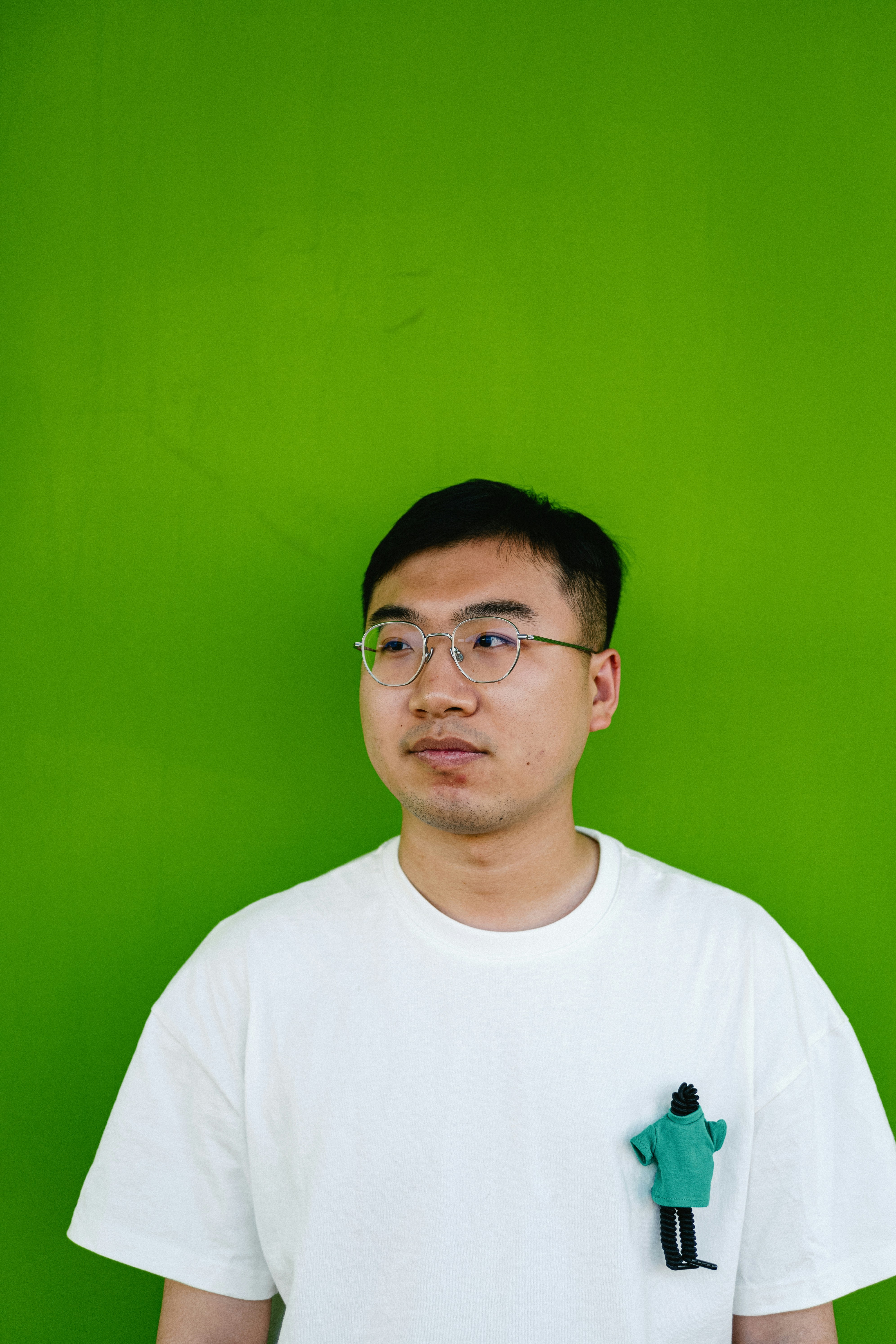 a man wearing glasses and a white t - shirt