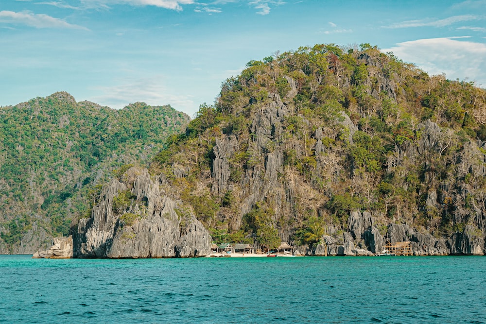 a large rock formation in the middle of a body of water