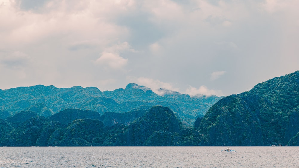 a large body of water with mountains in the background