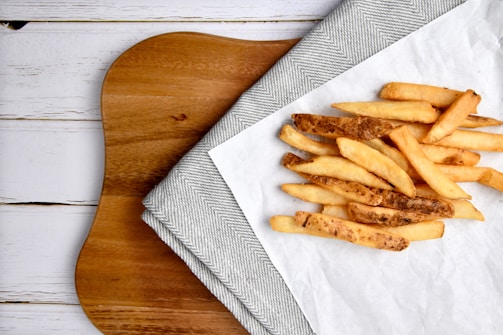 Freshly cut French fries laid out on a tray before freezing.