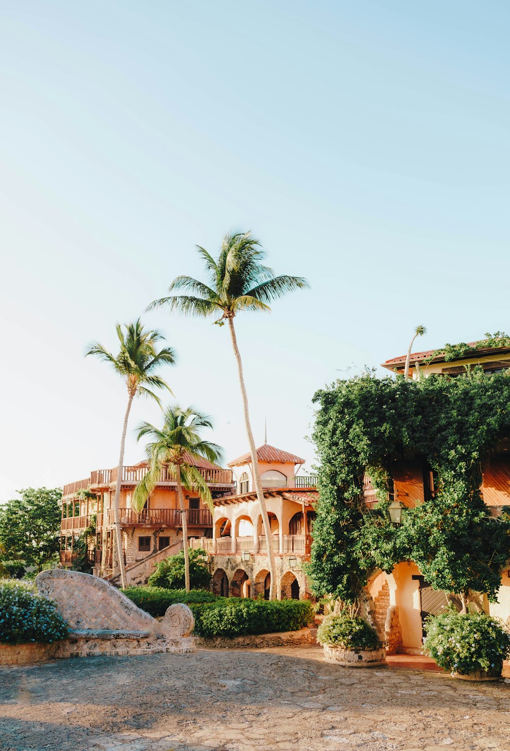 a large house with palm trees in front of it