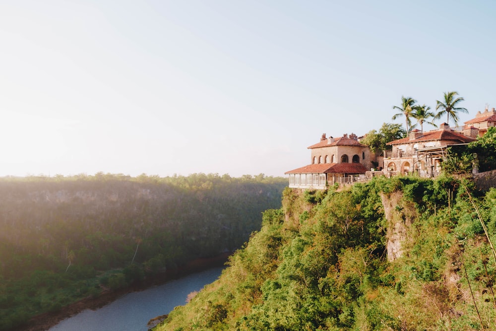 a house on a cliff overlooking a body of water