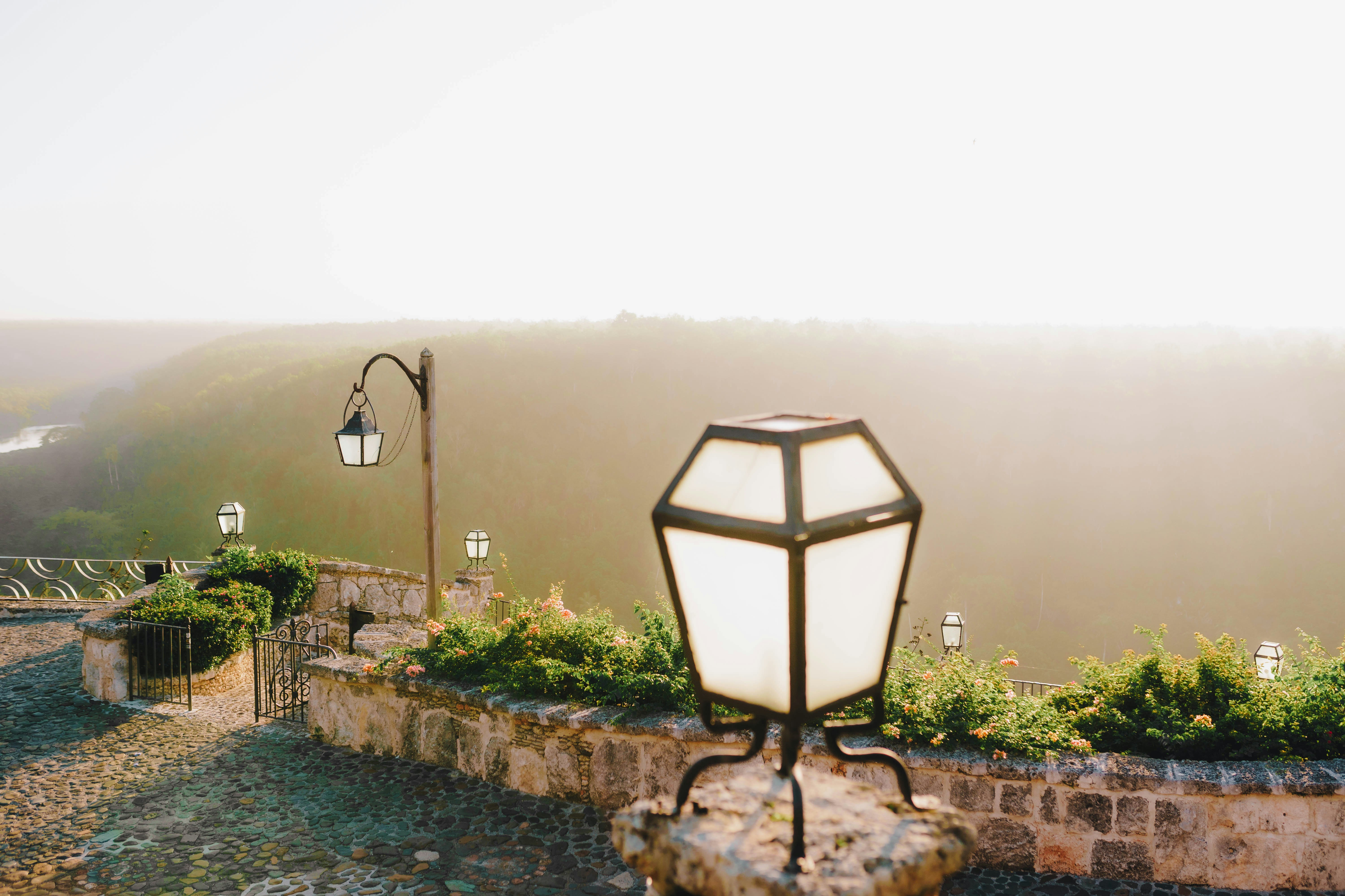 A street light sitting on top of a stone wall photo – Free Scenery ...