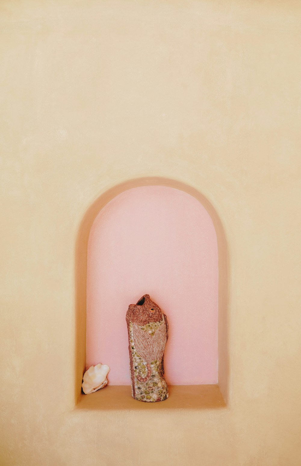 a vase sitting on top of a shelf next to a window