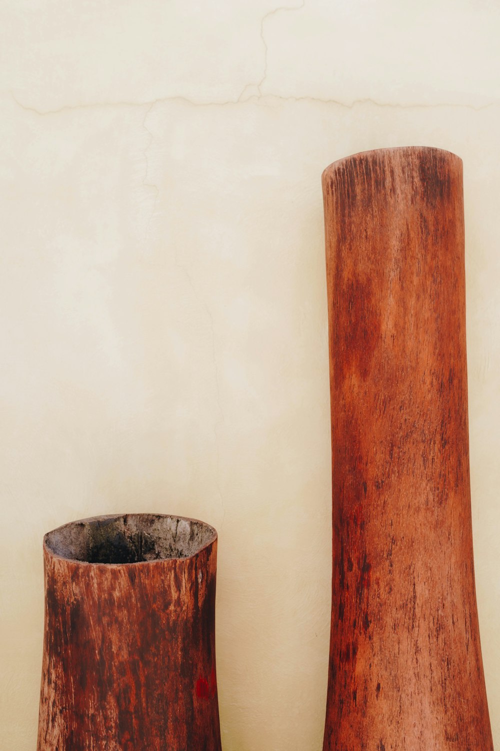 a couple of wooden vases sitting next to each other
