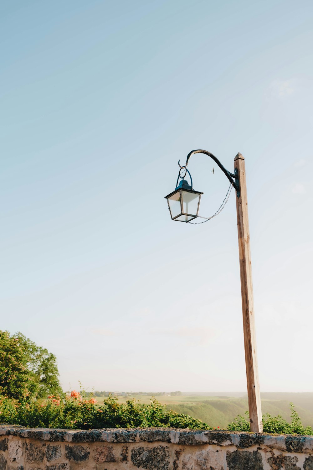 a lamp post with a light hanging off of it's side