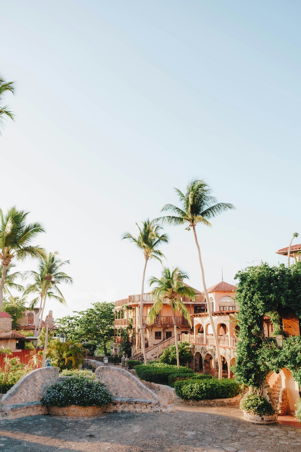 a large building with palm trees in the background