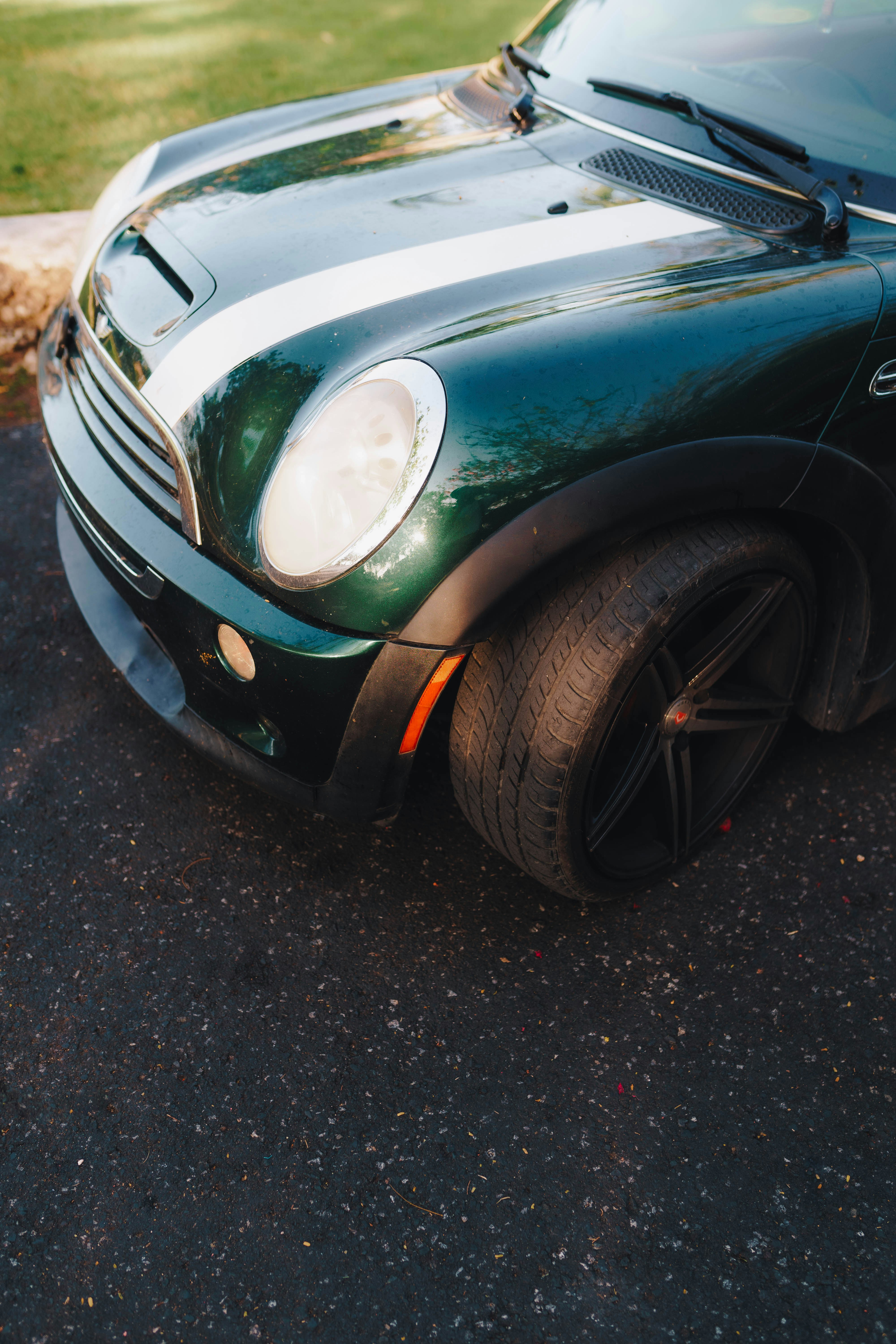 a green sports car parked in a parking lot
