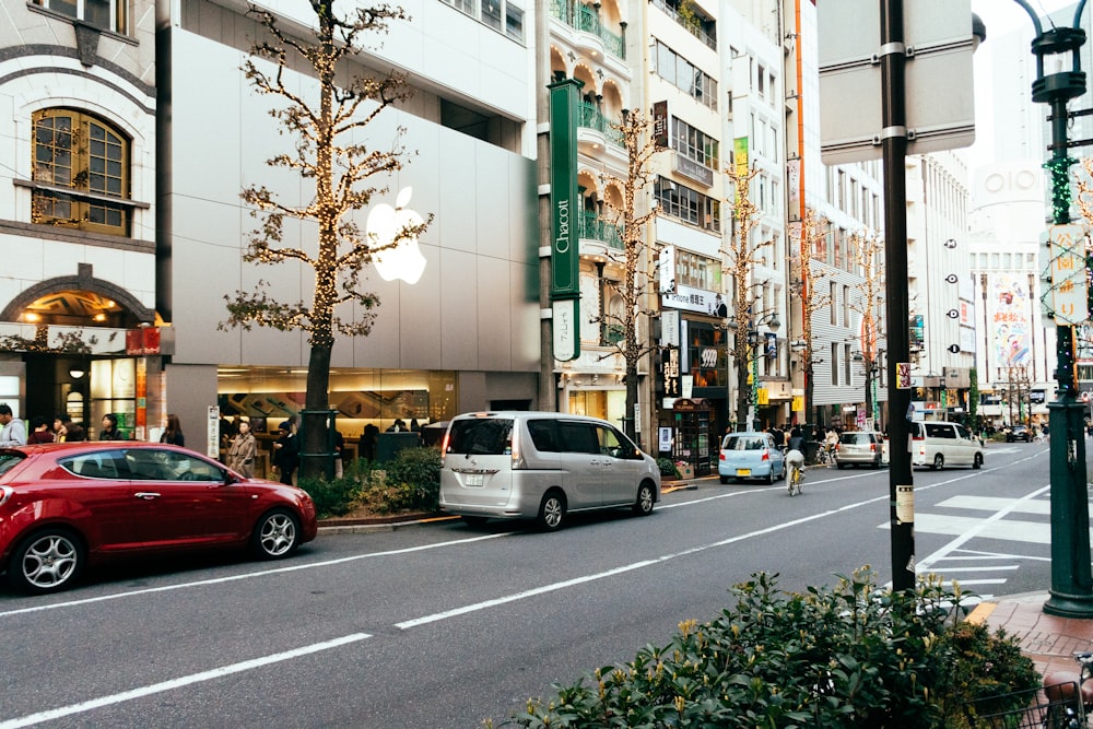 a city street filled with lots of traffic next to tall buildings