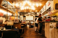 A cozy restaurant interior filled with happy diners.