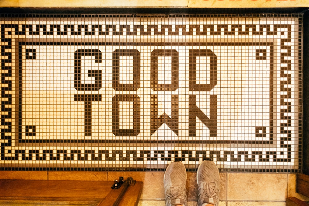 a person standing in front of a sign that says good town