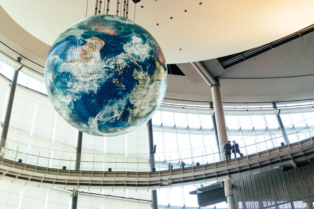 a large globe hanging from the ceiling of a building
