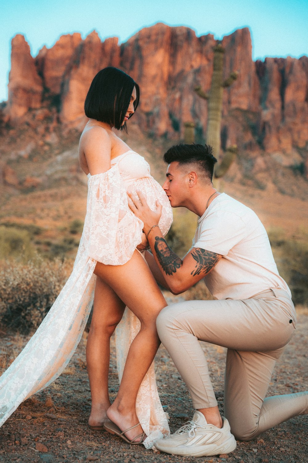 a man kneeling down next to a woman