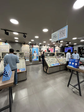 A modern optical store with AI-powered digital displays showing personalized eyewear recommendations.
