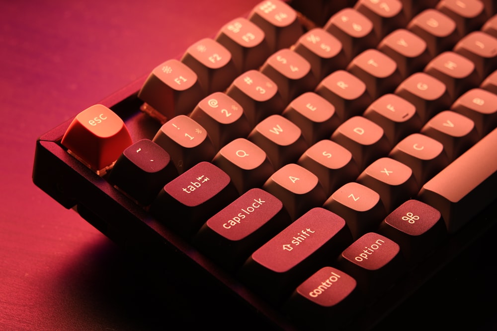 a close up of a pink and black keyboard