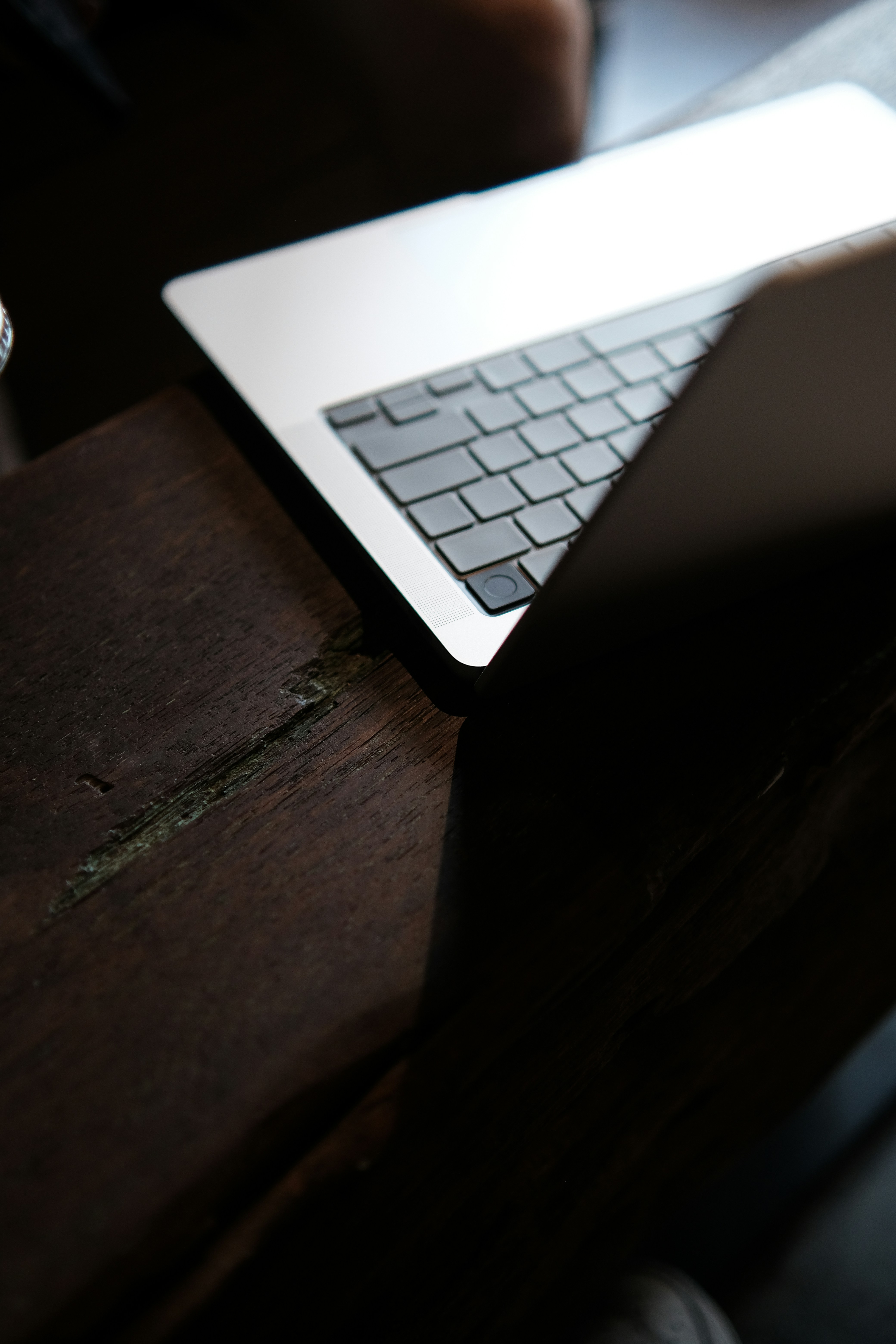 a laptop computer sitting on top of a wooden table