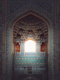 a window in a building with blue and green tiles