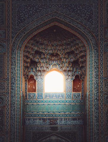 a window in a building with blue and green tiles