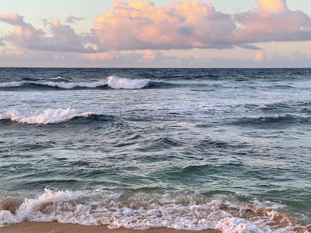 a beach with waves coming in to shore