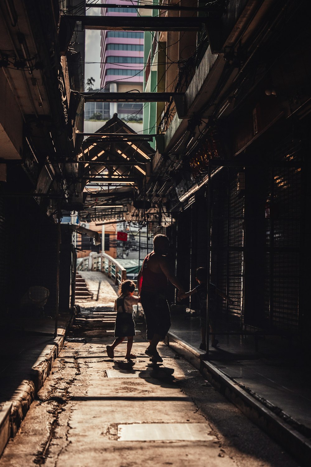 a man and a child walking down a street