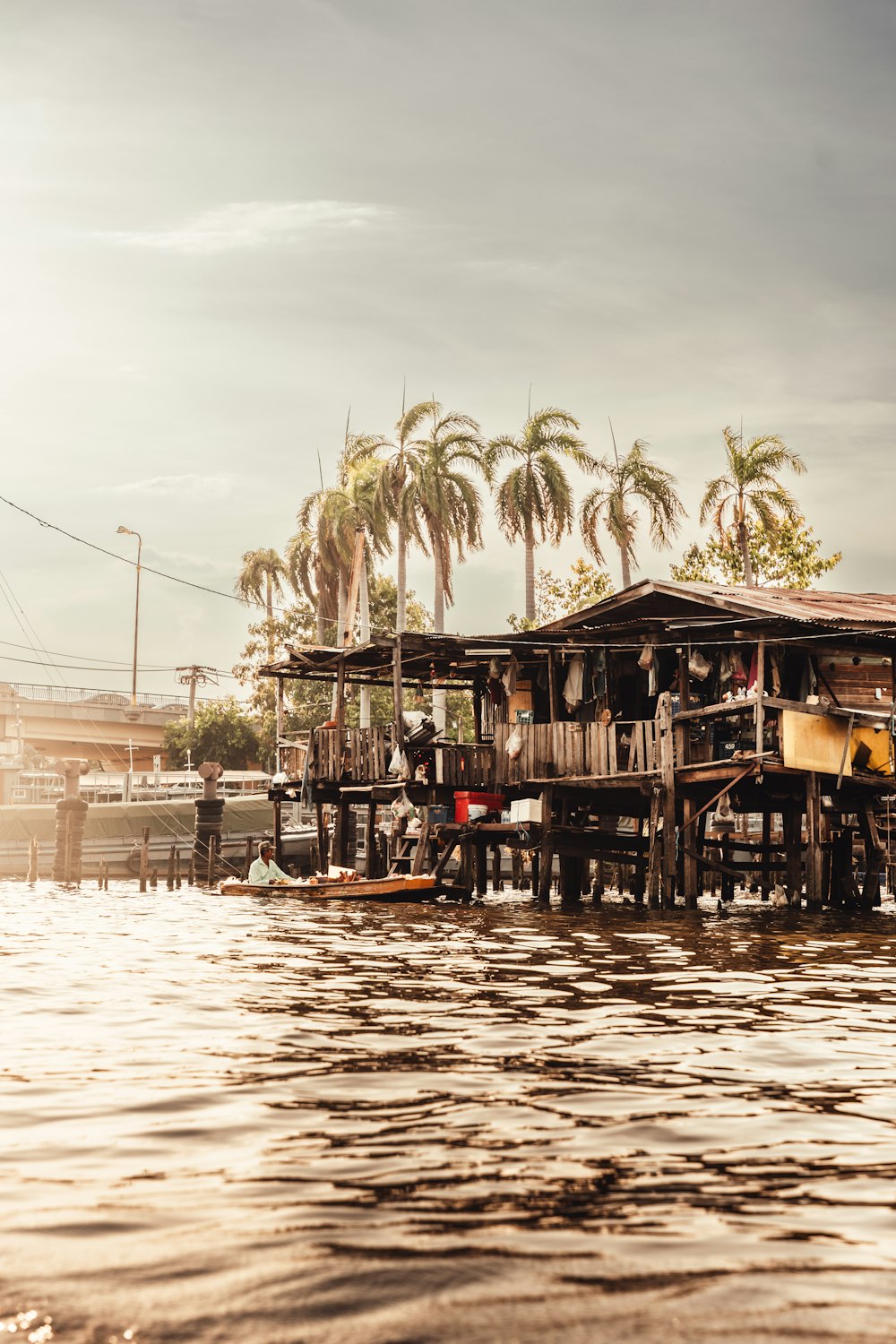 a group of people sitting on a dock next to a body of water