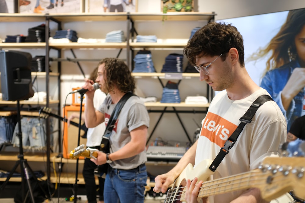 a man playing a bass guitar in a store