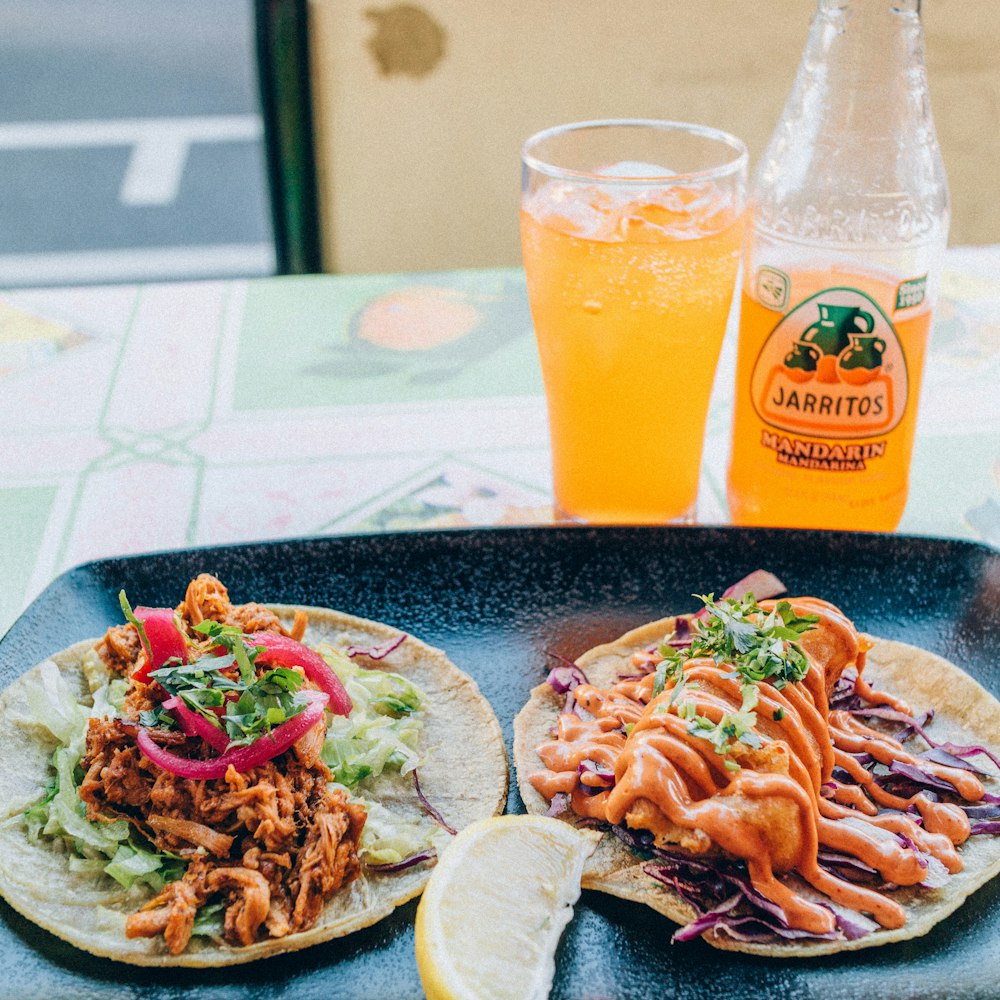 a couple of tacos sitting on top of a plate